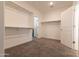 Spacious walk-in closet with built-in shelving and carpet floors at 19975 W Glenrosa Ave, Litchfield Park, AZ 85340