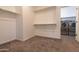 Walk-in closet with carpet and door leading into the laundry room at 19975 W Glenrosa Ave, Litchfield Park, AZ 85340