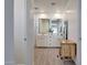 Bright bathroom featuring a double vanity, mirrors, wood-look tile flooring, and a spacious walk-in shower at 19990 W Turney Ave, Litchfield Park, AZ 85340