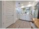 Bright bathroom featuring a double vanity, mirrors, wood-look tile flooring, and a spacious walk-in shower at 19990 W Turney Ave, Litchfield Park, AZ 85340