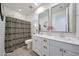 Stylish bathroom with double sinks, modern fixtures, and an elegant shower curtain at 19990 W Turney Ave, Litchfield Park, AZ 85340