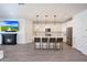 Open kitchen features white cabinets, an island with seating, and modern appliances at 19990 W Turney Ave, Litchfield Park, AZ 85340