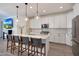 Modern kitchen island with barstools, stylish pendant lights, and white cabinets at 19990 W Turney Ave, Litchfield Park, AZ 85340