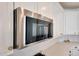 Modern stainless steel microwave seamlessly integrated within clean, white kitchen cabinets at 19990 W Turney Ave, Litchfield Park, AZ 85340