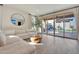 Modern living room featuring a comfortable sofa, stylish decor, and a large sliding glass door to the pool area at 19990 W Turney Ave, Litchfield Park, AZ 85340