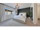 Stylish main bedroom featuring a modern accent wall, bright window, and contemporary light fixture at 19990 W Turney Ave, Litchfield Park, AZ 85340