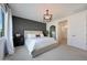 Serene main bedroom showcasing a modern accent wall, a bright window, and an open ensuite at 19990 W Turney Ave, Litchfield Park, AZ 85340