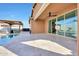 Tile patio with view of pool, cabana, and sliding glass doors creating an open, indoor-outdoor flow at 19990 W Turney Ave, Litchfield Park, AZ 85340