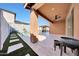 Covered patio with an outdoor kitchen, ceiling fan, and views of backyard pool and outdoor seating at 19990 W Turney Ave, Litchfield Park, AZ 85340