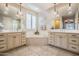 Bright bathroom boasts double sinks, a soaking tub, and neutral-toned tile flooring at 20138 E Estrella Rd, Queen Creek, AZ 85142