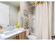 Well-lit bathroom featuring a shower/tub combo and a vanity with wood colored cabinets at 20138 E Estrella Rd, Queen Creek, AZ 85142