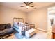 Comfortable bedroom featuring a ceiling fan, a metal frame bed, and wood look flooring at 20138 E Estrella Rd, Queen Creek, AZ 85142