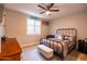 Cozy bedroom features a ceiling fan and a window with shutters at 20138 E Estrella Rd, Queen Creek, AZ 85142