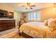 Bright bedroom features wood floors, a ceiling fan, and a window with shutters at 20138 E Estrella Rd, Queen Creek, AZ 85142