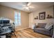 Comfortable bedroom with a pull-out sofa, wood floors and a ceiling fan at 20138 E Estrella Rd, Queen Creek, AZ 85142