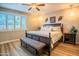 Comfortable bedroom features a window with shutters, wood floors and a padded bench at 20138 E Estrella Rd, Queen Creek, AZ 85142