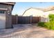 A brick driveway leads to a private, gated courtyard and a two-car garage at 20138 E Estrella Rd, Queen Creek, AZ 85142