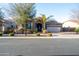 Charming home featuring a well-manicured front yard, lush landscaping, and a welcoming two-car garage at 20138 E Estrella Rd, Queen Creek, AZ 85142