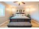 Elegant bedroom with dark wood furniture, accent lighting, and a patterned bench at 20138 E Estrella Rd, Queen Creek, AZ 85142