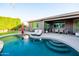 Backyard pool featuring lounge chairs and lush greenery at 20138 E Estrella Rd, Queen Creek, AZ 85142