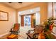 Cozy sitting area with comfortable chairs and open access to a media room creating a versatile living space at 20138 E Estrella Rd, Queen Creek, AZ 85142