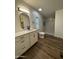 Bathroom featuring a modern vanity, sleek fixtures, and walk in shower with striking white marble at 2034 E Charleston Ave, Phoenix, AZ 85022