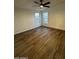 Bedroom with wood-look floors, a modern ceiling fan, and lots of natural light at 2034 E Charleston Ave, Phoenix, AZ 85022