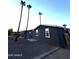 Exterior view of charming home with low maintenance rock landscaping and towering palms at 2034 E Charleston Ave, Phoenix, AZ 85022