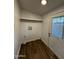 A mud room featuring wood floors, utility hook ups and an exterior door at 2034 E Charleston Ave, Phoenix, AZ 85022