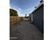 A side yard with new wooden fence, gravel and concrete steps, perfect for outdoor enjoyment at 2034 E Charleston Ave, Phoenix, AZ 85022