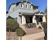 Two-story home boasts light blue siding, stone accents, and covered porch with column supports at 21134 W Green St, Buckeye, AZ 85396