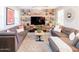 Stylish living room featuring a brick wall with shelving, a plush rug and comfortable seating at 21134 W Green St, Buckeye, AZ 85396