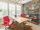 Stylish office space featuring a rustic wood accent wall, industrial shelving, and bright windows at 21134 W Green St, Buckeye, AZ 85396