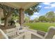 Inviting covered back porch with comfortable seating and a view of the lush green lawn at 2170 E Caroline Ln, Tempe, AZ 85284