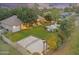 Aerial view of backyard featuring a pool, tennis court, well-manicured lawn, and outdoor living space at 2170 E Caroline Ln, Tempe, AZ 85284