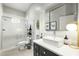 Bright bathroom featuring white vanity, vessel sink, door to patio, and tile shower with glass door at 2170 E Caroline Ln, Tempe, AZ 85284