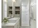 Bright bathroom featuring a modern sink, white shower, and built-in shelving at 2170 E Caroline Ln, Tempe, AZ 85284