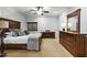 Comfortable bedroom featuring a ceiling fan, dresser with a large mirror, and a built in desk at 2170 E Caroline Ln, Tempe, AZ 85284