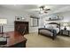 Comfortable bedroom featuring a ceiling fan, built-in shelving, and neutral tones at 2170 E Caroline Ln, Tempe, AZ 85284