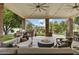 Relaxing covered patio featuring a fire pit and grill area overlooks a refreshing pool at 2170 E Caroline Ln, Tempe, AZ 85284