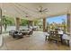 Covered patio with outdoor furniture and ceiling fans overlooks the pool and backyard area at 2170 E Caroline Ln, Tempe, AZ 85284