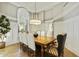 Elegant dining room with hardwood floors, stylish chandelier, and a large window with shutters providing natural light at 2170 E Caroline Ln, Tempe, AZ 85284