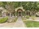 An inviting front entrance with flowerbeds, mature trees, and a walkway leading to the front door at 2170 E Caroline Ln, Tempe, AZ 85284