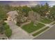 Aerial view of the home's front yard showcasing the lawn, mature trees, driveway, and garage at 2170 E Caroline Ln, Tempe, AZ 85284