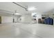 Large garage features epoxy floors, built-in storage and cabinets, plus additional room for workspace at 2170 E Caroline Ln, Tempe, AZ 85284