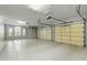 Spacious garage with three doors and epoxy floors offers ample storage and natural light at 2170 E Caroline Ln, Tempe, AZ 85284