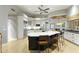 Large kitchen featuring a dark island, white cabinets, and stainless steel appliances at 2170 E Caroline Ln, Tempe, AZ 85284