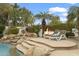 This backyard oasis has a rock waterfall, lounge chairs and a fire pit for entertaining at 2170 E Caroline Ln, Tempe, AZ 85284