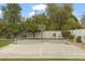 Private sport court area with tennis net and basketball hoop at 2170 E Caroline Ln, Tempe, AZ 85284