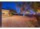 Landscaped backyard with desert landscaping and a wrought iron fence separating the property from the golf course at 22813 N Del Monte Dr, Sun City West, AZ 85375